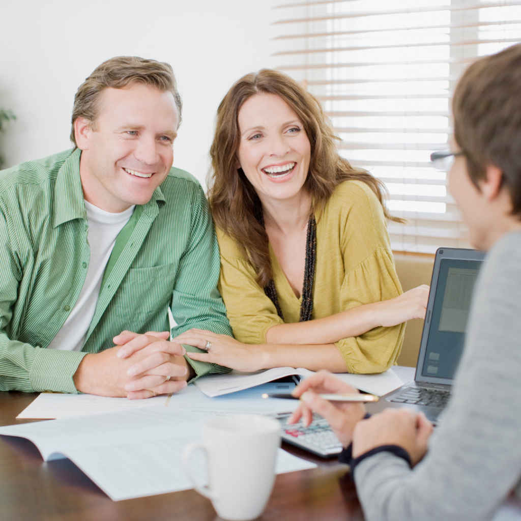 Happy couple meeting with loan officer