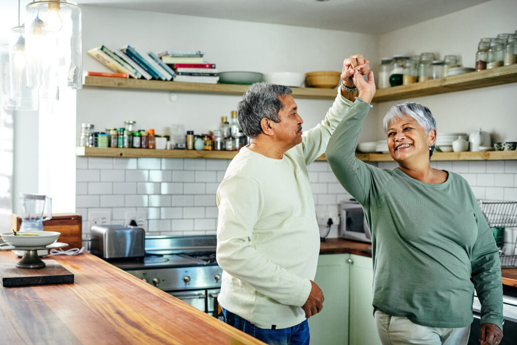 Shot of a happy senior couple dancing in their kitchen at home