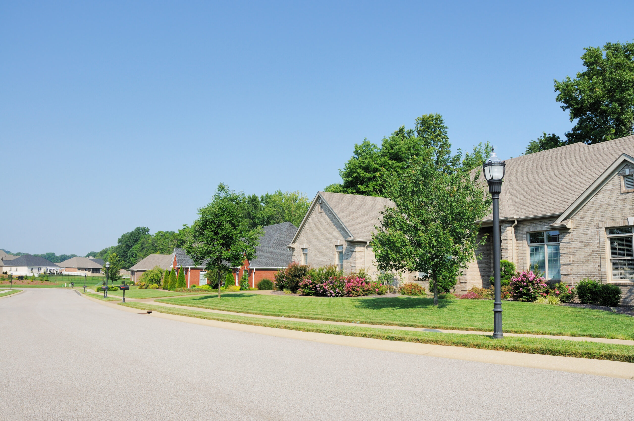 A street view of luxury homes in an upscale subdivision in Indiana.